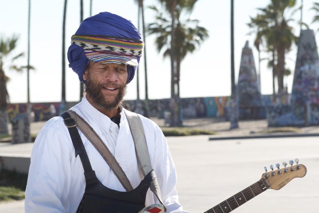 Turbaned Musician Amidst Palm Trees
