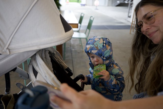 Family Moment at Cafe with Toddler in Blue Snowsuit