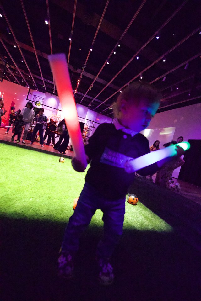 Child with Glowing Lightsaber at Baby Rave Event