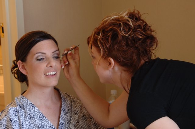 Bridal Makeup Artist Applies Final Touches Before Wedding