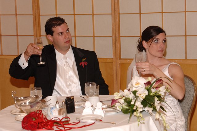 Bride and Groom Toast at Wedding Reception Table