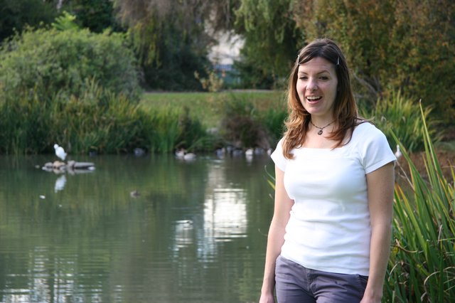 Woman Laughing by a Tranquil Park Pond