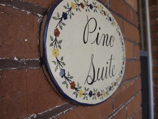 Pine Suite Sign on Brick Wall