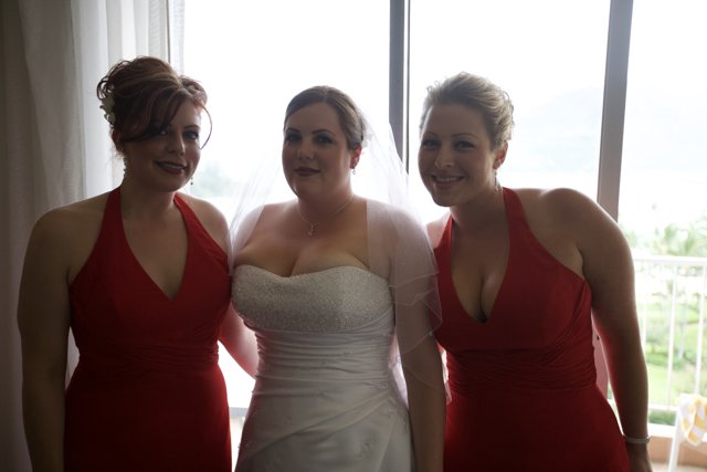 Three Women in Red Evening Dresses at a Wedding Ceremony