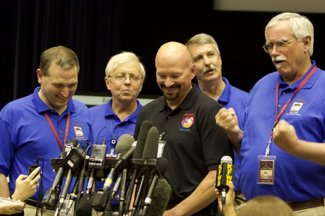 Blue-Shirted Men at Post-Interview Press Conference