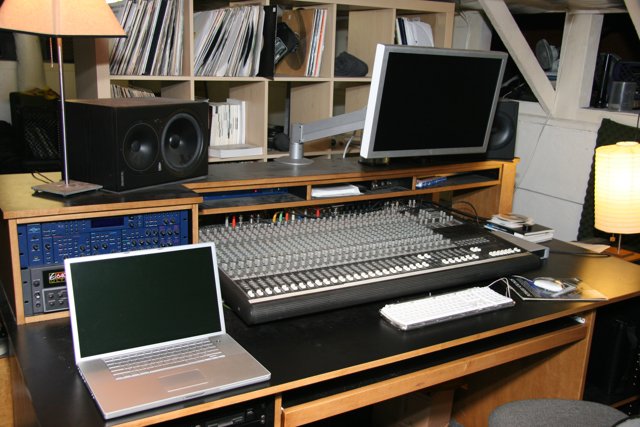 Black Desk with Computer Equipment and Speakers