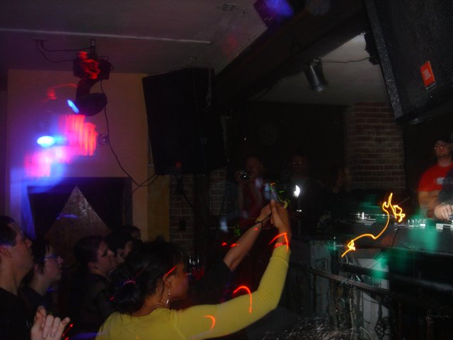 Woman in Yellow Shirt Shines in Urban Nightclub