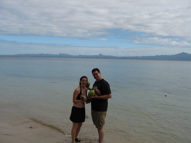 Couple Celebrating Fresh Coconuts on Fijian Beach