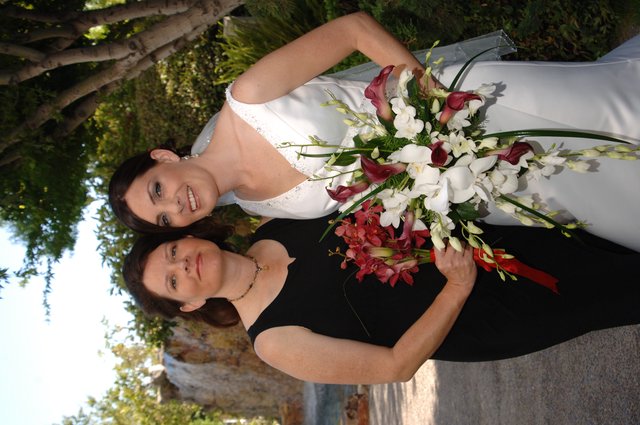 Bride and Bridesmaid Pose at Outdoor Wedding Venue