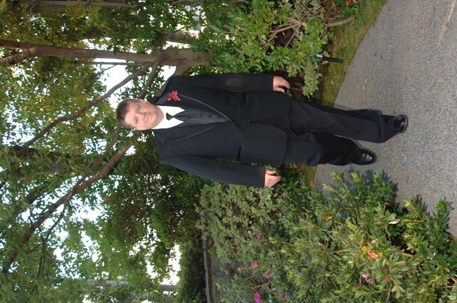 Dapper Groom Walking Garden Path Before Wedding