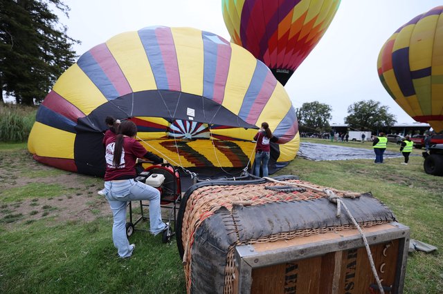 Volunteer Crew Inflating Hot Air Balloons at Dawn