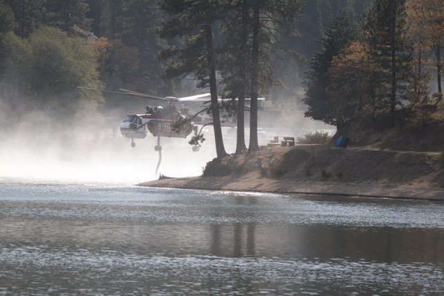 Firefighting Helicopter Sprays Water on Lake