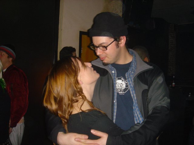 Intimate Couple Dancing at Dimly Lit Venue