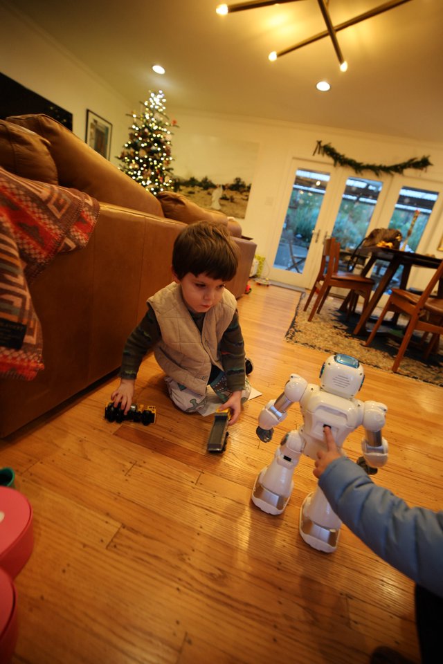 Child Playing with Robot Toys on Christmas Eve