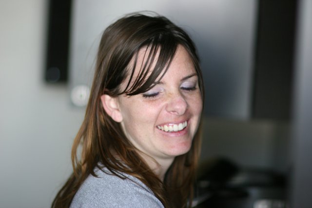Joyful Woman Laughing in Casual Indoor Setting