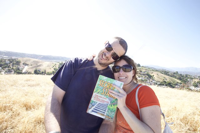 Couple Poses with Secret Stairs Book on LA Hillside