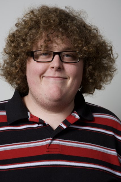 Happy Man with Curly Hair and Glasses
