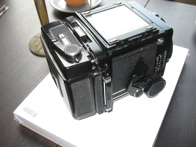 Sleek Digital Camera on White Box
