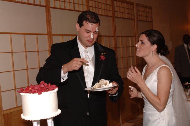 Bride and Groom Share Playful Wedding Cake Moment