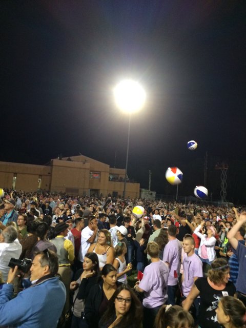Nighttime Volleyball Game with a Lively Crowd