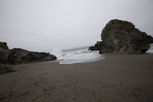 Rugged Cove Where Wild Waves Meet Dark Sand