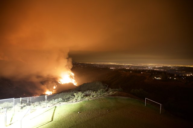 Flames engulf the hills at night
