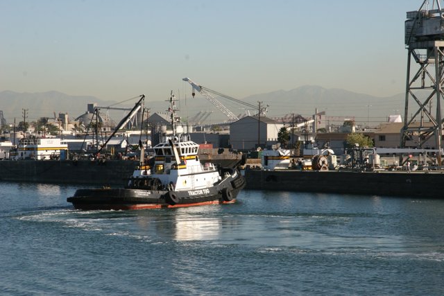 Tugboat Guiding Barge at the Port