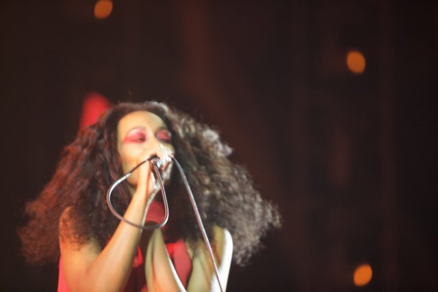 Curly-Haired Singer Shines on Stage