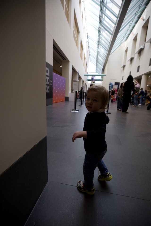 Toddler Exploring Modern Museum Atrium Space