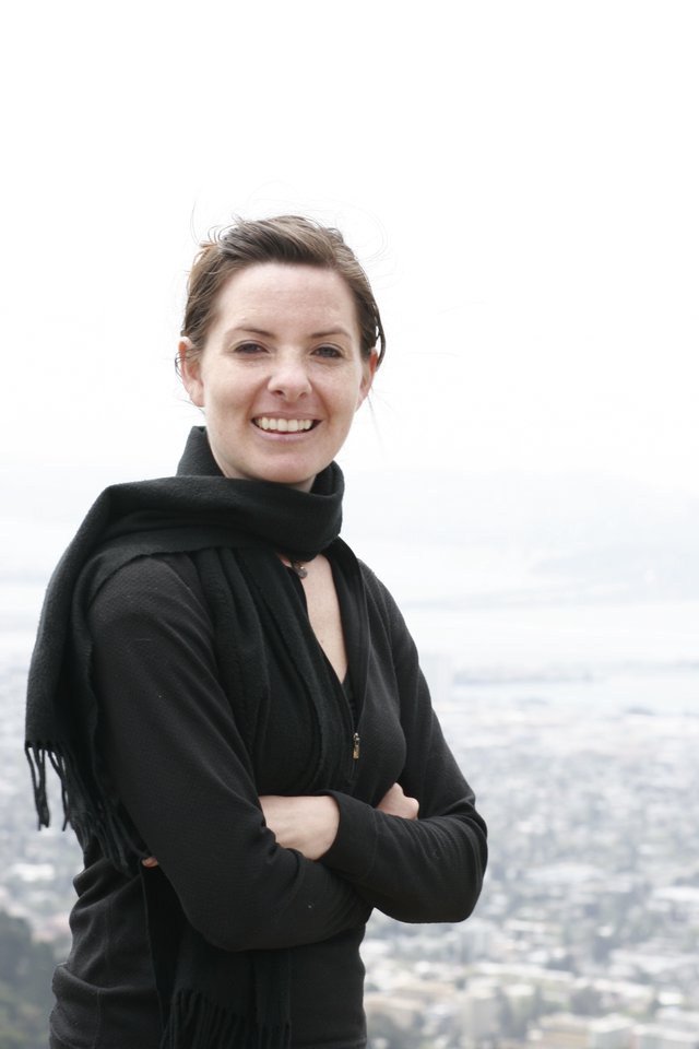Smiling Woman Overlooking Foggy San Francisco Cityscape