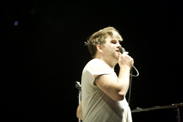 James Murphy performing with a Microphone