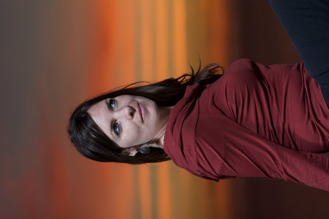 Woman Gazing Skyward Against a Fiery Sunset
