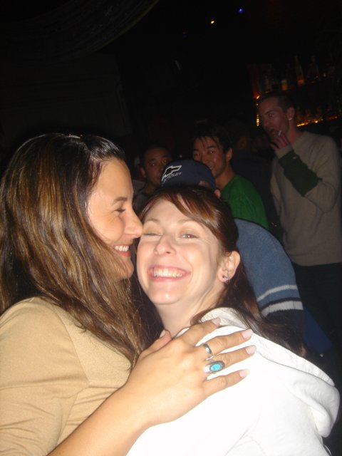 Women Embracing at Night Club
