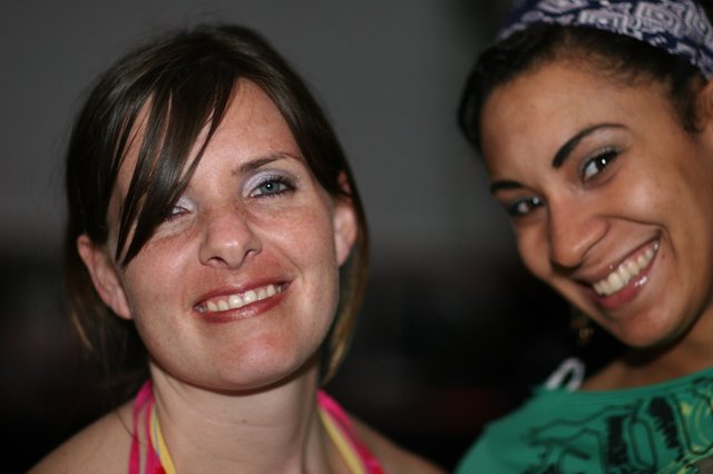 Two Smiling Women Posing Together at Social Event