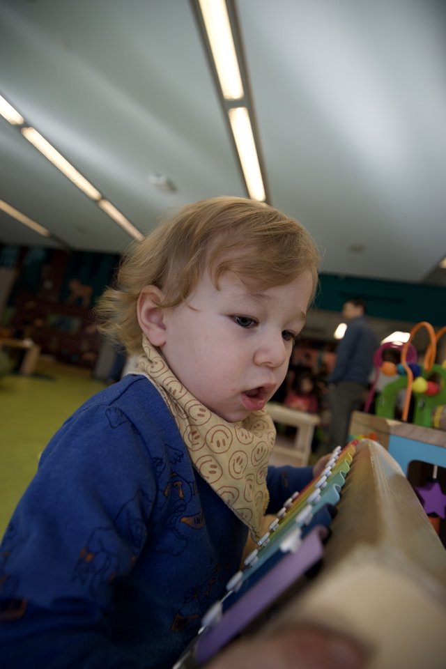 Young Child Reading Picture Book in Classroom