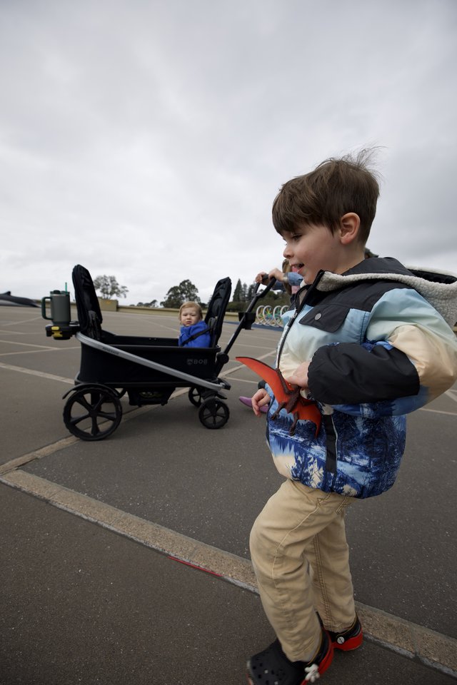 Young Boy Playing with Toy at Outdoor Parking Lot