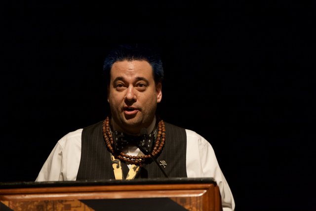 Blue-haired Man giving a Speech