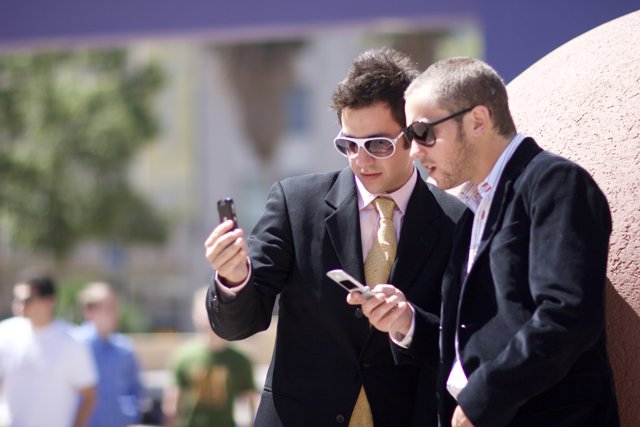 Businessmen Busy with Electronics