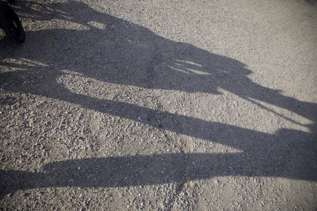 Shadow of a Child on Textured Pavement