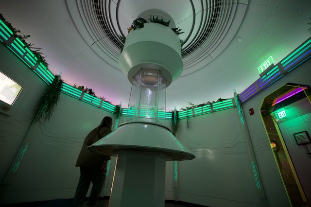 Futuristic Museum Interior with Cylindrical Light Installation