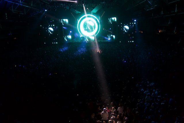 Green Spotlight Shines Down on Concert Crowd