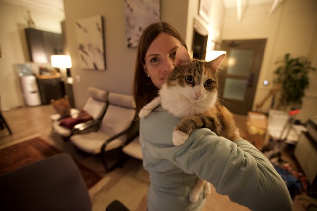 Woman Proudly Presents Fluffy Cat to Camera