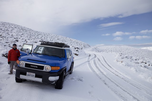 Blue FJ Cruiser Adventure on Snow-Covered Mountain Road