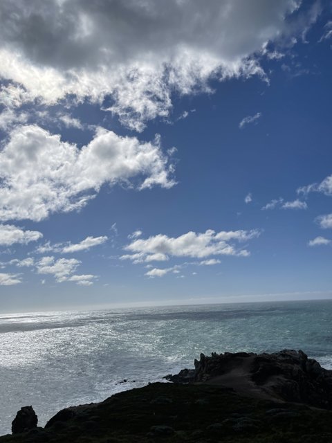 Cliffside vista of the majestic ocean and clouds