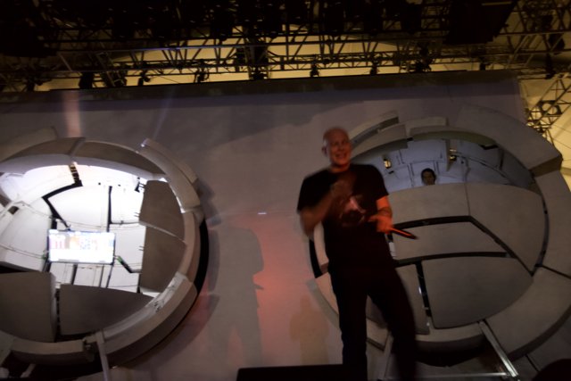 Man on a Stage with a Stunning Sphere Screen