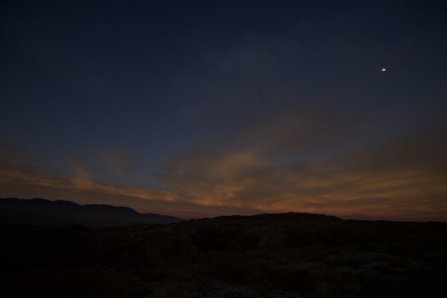 Desert Sunset with Moon and Sun