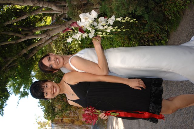 Bride and Bridesmaid Pose Together at Outdoor Wedding