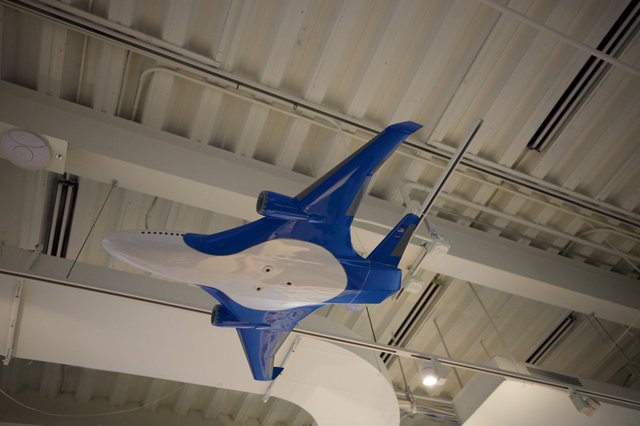 Blue Fighter Jet Model Suspended from Museum Ceiling