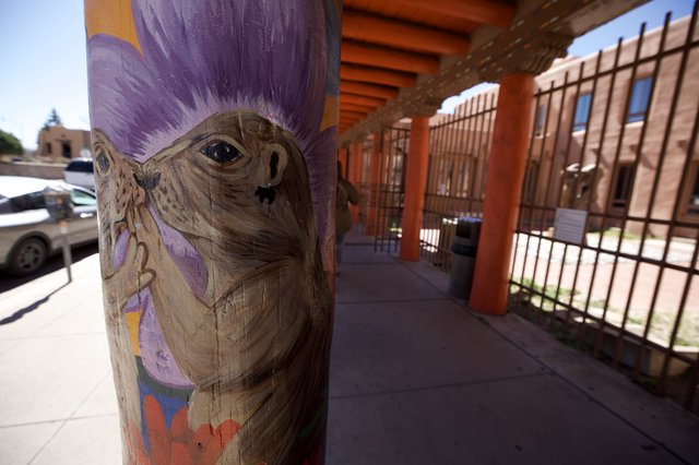Painted Wooden Post with Purple-Haired Character at Adobe Portal