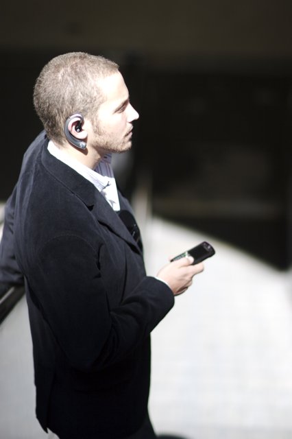 Businessman on the Phone Caption: A suited man stays connected with his cell phone during a business shoot for Flexilis.